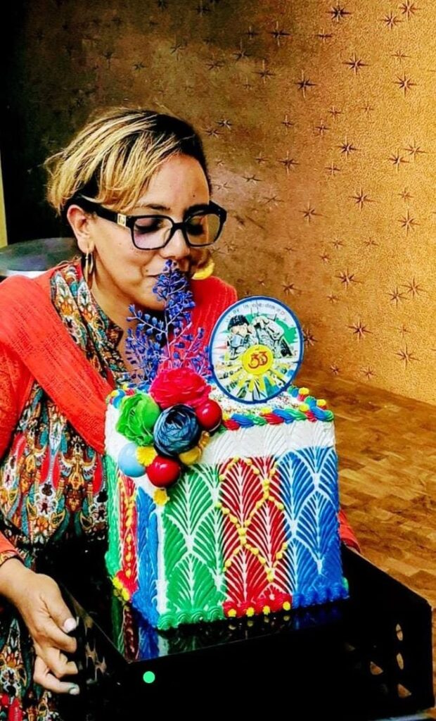 Cake artist finishing a colourful celebration cake