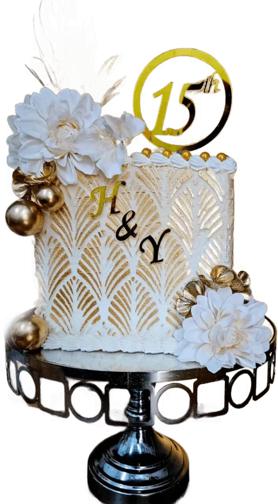 White and gold 15th birthday cake with flowers