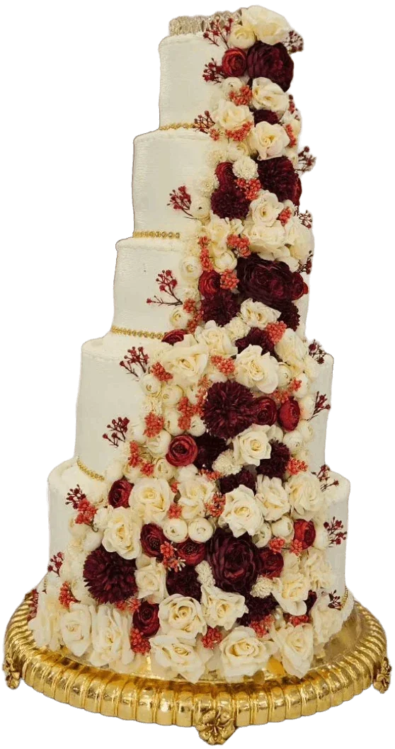 Five-level white wedding cake cascading with red and blush roses