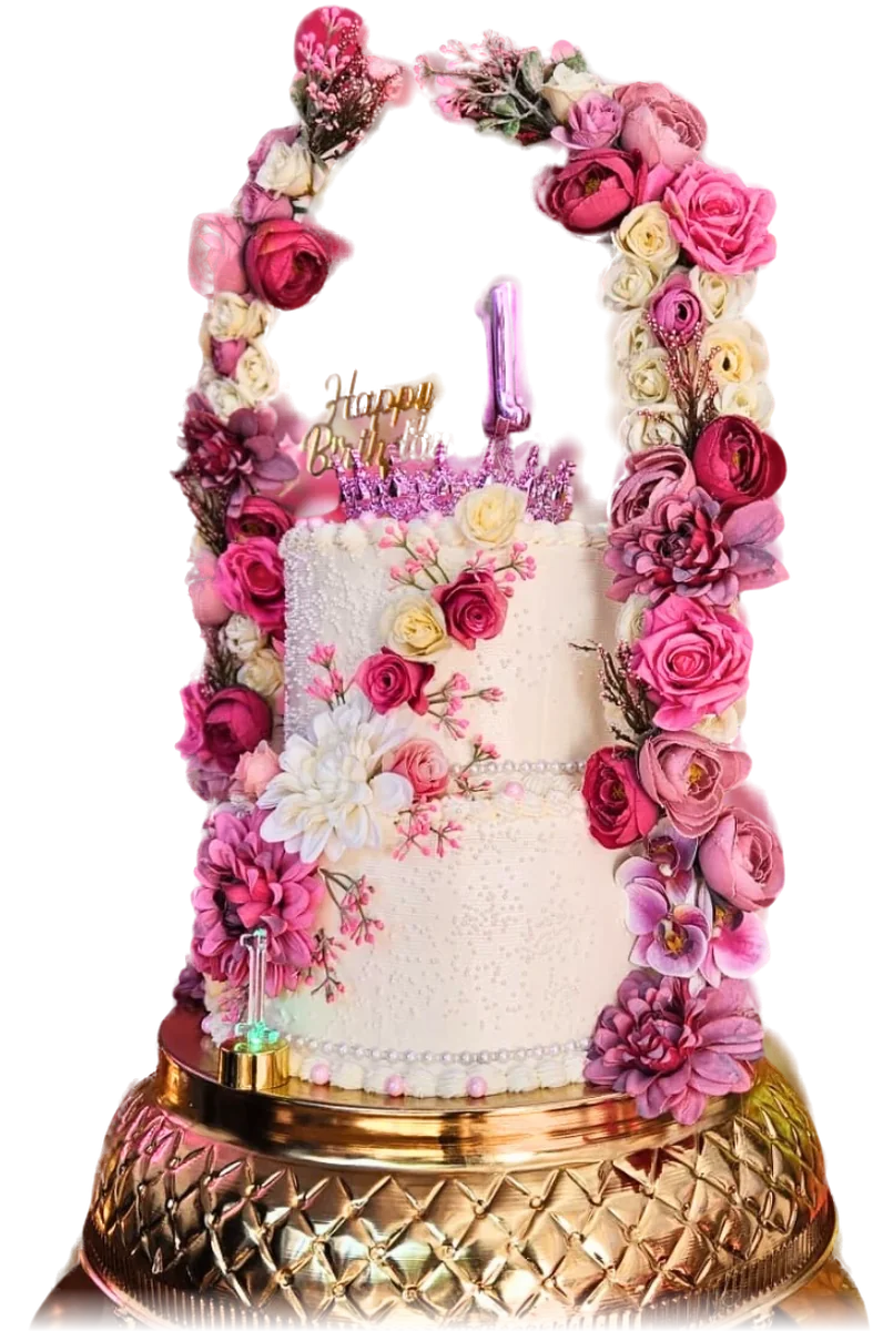 Tall white birthday cake decorated with pink and blush roses