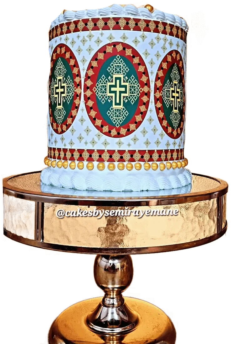 Graduation cake with a traditional Eritrean pattern on a gold stand