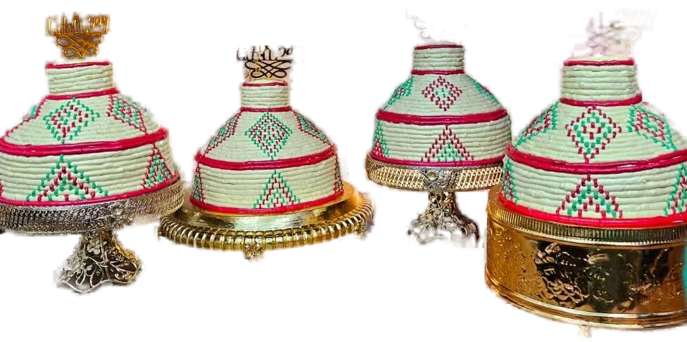 Three mesob-style cakes on gold stands