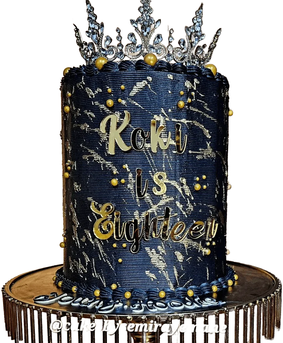 Navy and gold celebration cake with a silver crown topper