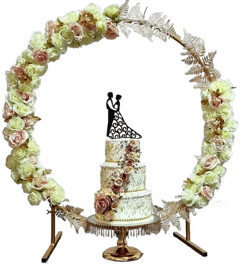 Small wedding cake under a floral hoop with a couple topper